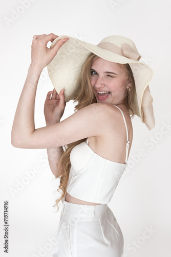 Portrait of beauty woman smiles playfully from ear to ear with one eye closed and winks at camera