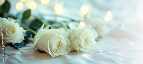 Serene bouquet of white roses against a gentle  luminous backdrop.