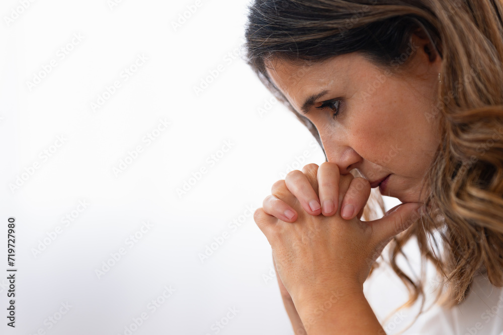 Photo with copy space and close-up of a sad woman thinking looking down Photo with copy space and close-up of a sad woman thinking looking down