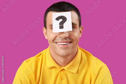 Young man with paper questi...