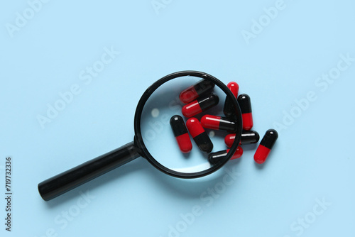 Magnifier with pills on blu...