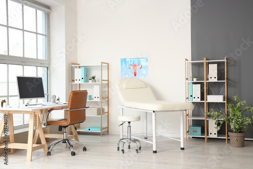 Interior of gynecologist's office with workplace and couch photo
