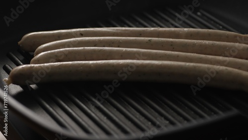 Raw Sausages weisswurst on Grill Pan. Close-up, shallow dof.
