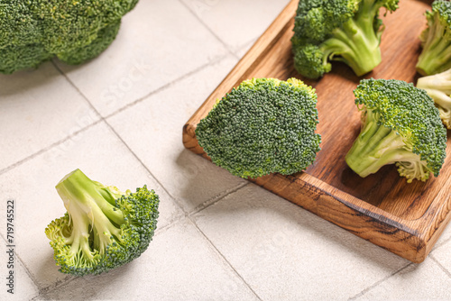 Fresh green broccoli with wooden board on white tile background