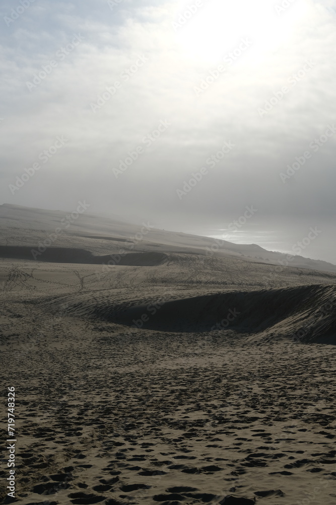 A view from the top of the Pilat dune with some fog on the silver coast. La Teste-de-Buch, France - January 25, 2024.