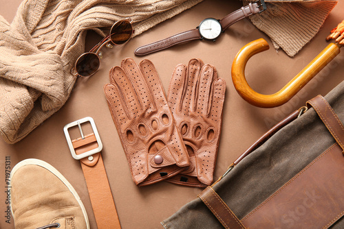 Composition with leather male gloves and different accessories on color background