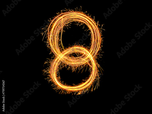 Alphabet and Number eight sparklers on black background by light painting.number 8 sparkling golden for party and Celebrate