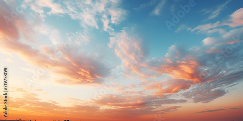 A beautiful sky with blue orange yellow and pink wispy clouds Orange Sky at Dawn Day Summer sunrise blue sky panorama with fleece clouds morning good weather background. © sumia