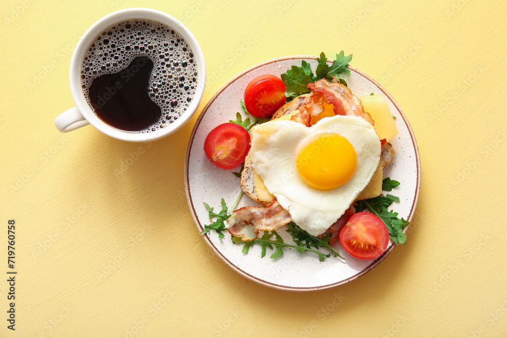 Plate with tasty fried egg, toast, bacon, tomatoes and cup of coffee on beige background Plate with tasty fried egg, toast, bacon, tomatoes and cup of coffee on beige background