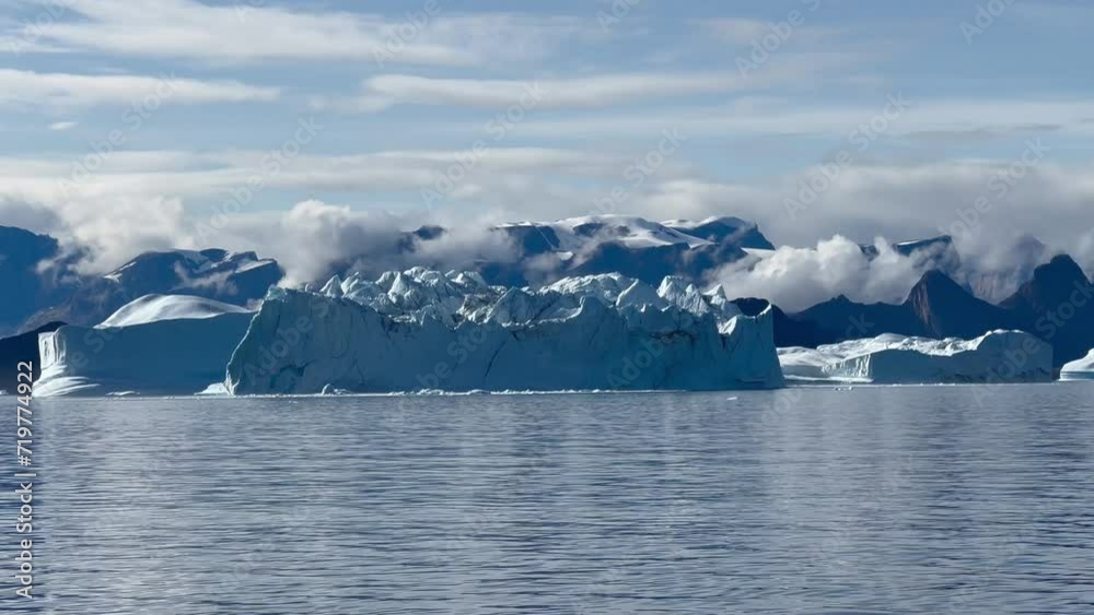 Hall Bredning view with iceberg and mountains on backround. Scoresbysund, Greenland.