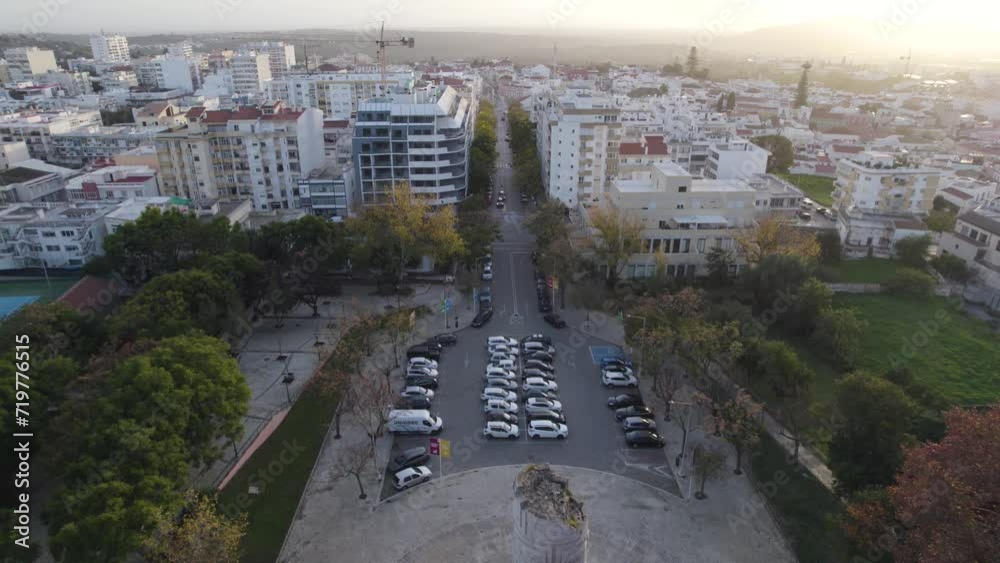 Drone flying backwards revealing Engineer Duarte Pacheco's Monument with Loulé cityscape in Background Drone flying backwards revealing Engineer Duarte Pacheco's Monument with Loulé cityscape in Background