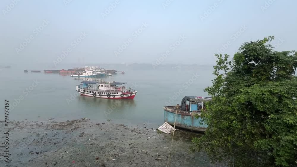 Profile view of a ferry boat sailing on Ganga river during daytime in Kolkata, India. Profile view of a ferry boat sailing on Ganga river during daytime in Kolkata, India.
