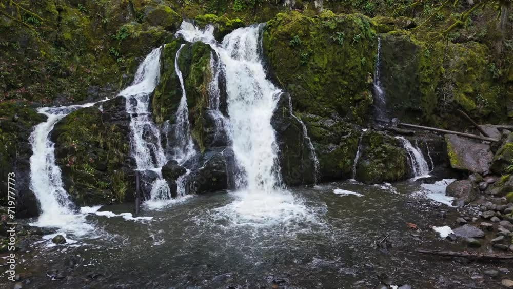 Waterfall flowing through moss rocks in the pacific northwest. Waterfall flowing through moss rocks in the pacific northwest.