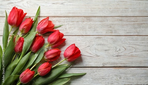 Beautiful red spring tulips on pink wooden background  flat lay. Space for text. Valentine s day concept.