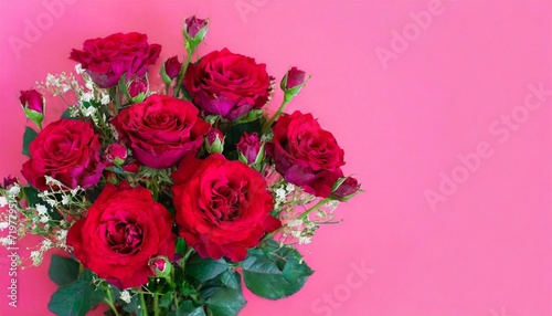 Bouquet of lush and small red roses on bright pink background with copy space and place for text . Holiday greeting card to Mother day  International Woman Day  Valentine Day. 