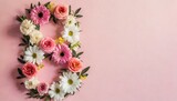 Flowers in the shape of number 8 on a pink background with place for text 