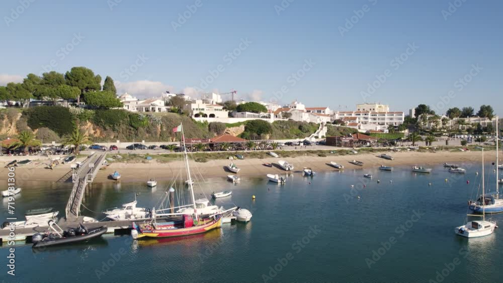 Aerial dolly sideways along Alvor coastline, Sailing boats by the pier and beach, Algarve Aerial dolly sideways along Alvor coastline, Sailing boats by the pier and beach, Algarve