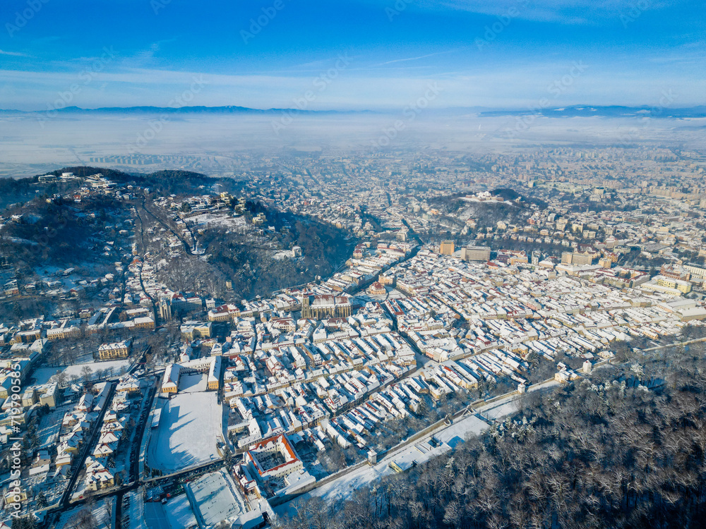 Aerial view of the old historic town of Brasov during a sunny day in winter, Romania