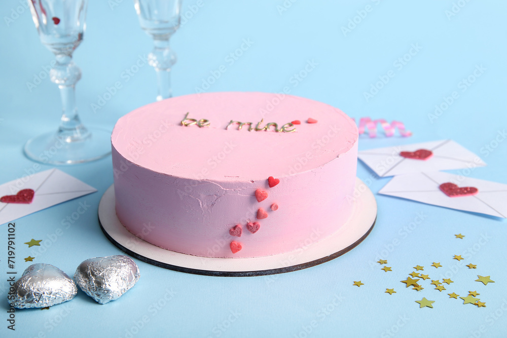 Pink bento cake with envelopes and candies on blue background. Valentine's Day celebration Pink bento cake with envelopes and candies on blue background. Valentine's Day celebration
