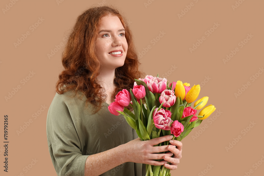 Happy young woman with bouquet of beautiful tulips on brown background. International Women's Day