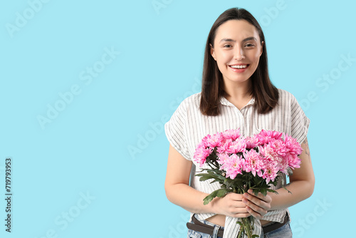 Smiling young woman holding...