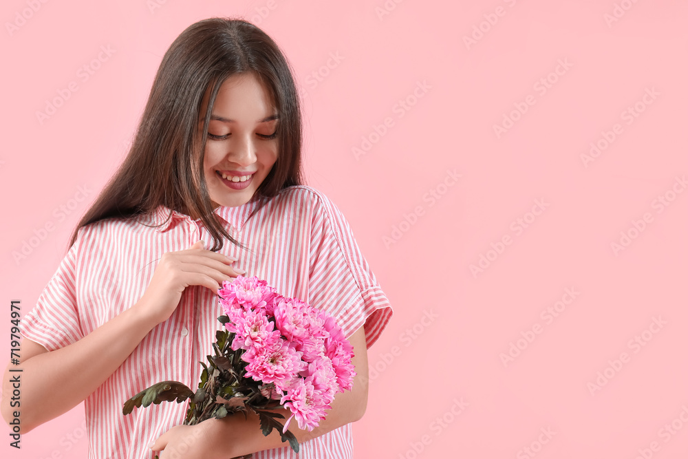 Beautiful young Asian woman with bouquet of pink chrysanthemum flowers on color background. International Women's Day Beautiful young Asian woman with bouquet of pink chrysanthemum flowers on color background. International Women's Day