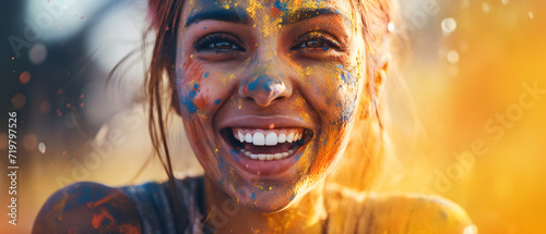 A woman's face reflects joy during Holi festival celebration with colorful paint photo