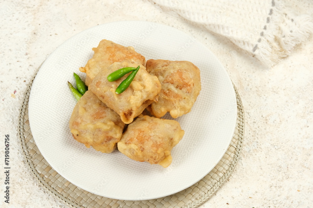 gorengan tahu isi and green cayenne on a plate gorengan tahu isi and green cayenne on a plate
