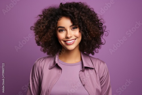 Confident young black woman smiling on purple background
