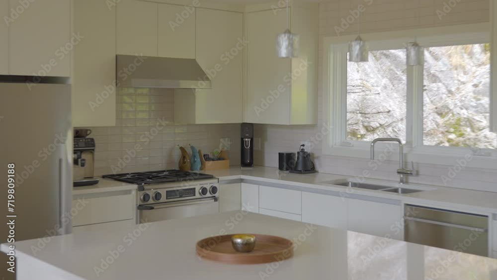 Establishing shot of modern, bright, clean kitchen interior with stainless steel appliances in a luxury house. ProRes 422 HQ. Establishing shot of modern, bright, clean kitchen interior with stainless steel appliances in a luxury house. ProRes 422 HQ.