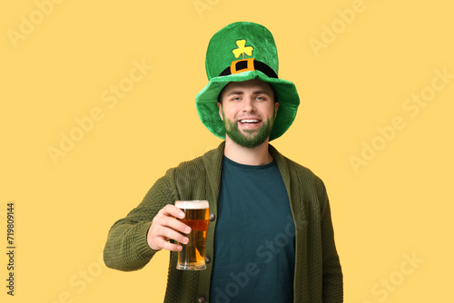 Smiling man with green bear...