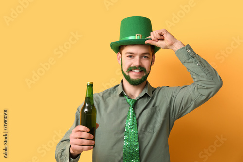 Smiling man with green bear...