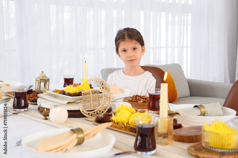 Little Muslim girl having dinner at home. Ramadan celebration Little Muslim girl having dinner at home. Ramadan celebration