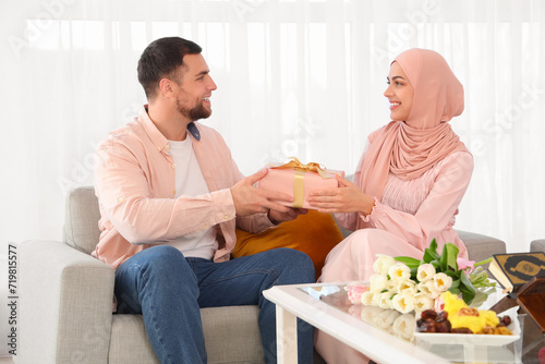 Happy Muslim couple with gi...
