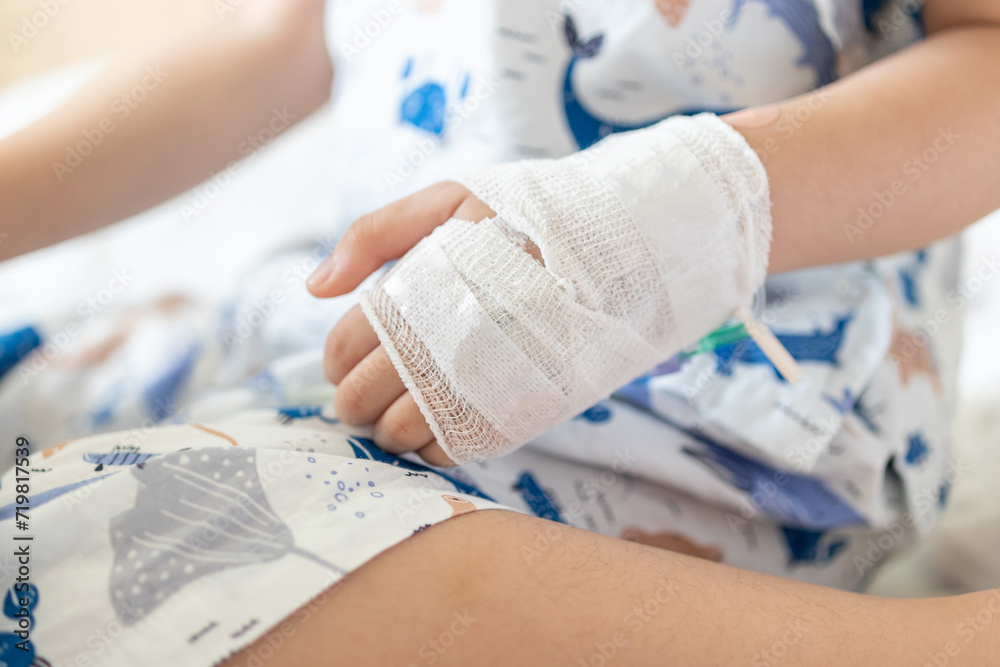 Close up child hand with saline IV solution in hospital Close up child hand with saline IV solution in hospital
