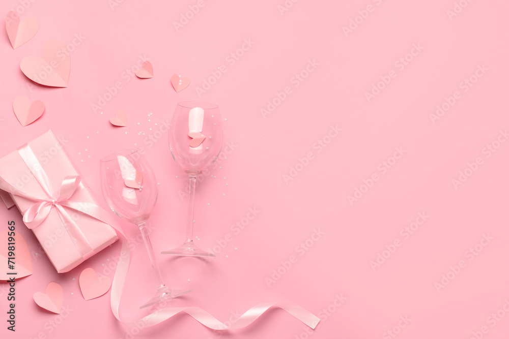 Composition with gift box, paper hearts and glasses for Valentine's Day celebration on pink background