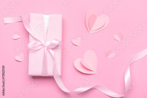 Composition with gift box and paper hearts for Valentine's Day celebration on pink background © Pixel-Shot