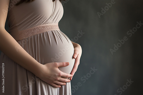 お腹に手を置いている妊婦 photo