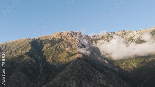 Rugged Cuka Partizan mountain range in Albania during blue sky day with shadow photo