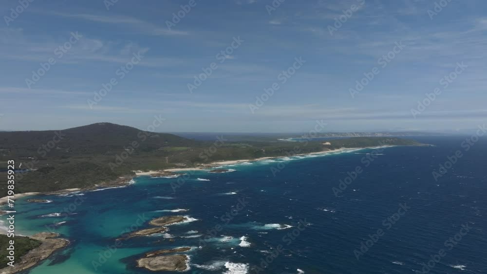 High altitude panning shot of William Bay National park looking out towards the wind farm in the distance. High altitude panning shot of William Bay National park looking out towards the wind farm in the distance.