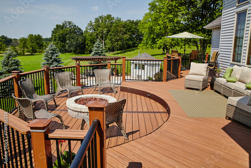 Luxury Outdoor Deck with Fire Pit Seating and Rattan Lounge Area