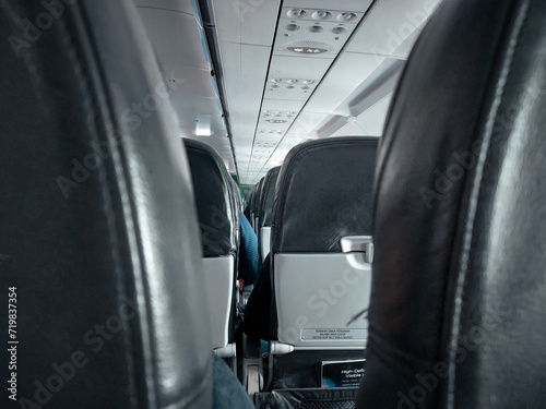 Obraz na plátne photo of row of seats in the plane full of people taken from behind of the middl