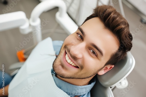 A happy man is sitting in a dentist s chair and looking directly at the camera. Capture the positive atmosphere and her contentment during the dental visit