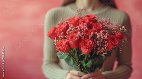 Young woman hands holding bouquet red roses with lights in background, romantic and charm atmosphere background. Valentine concept.