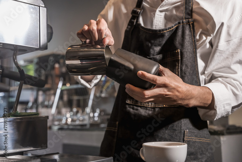 Barista making coffee in coffee shop