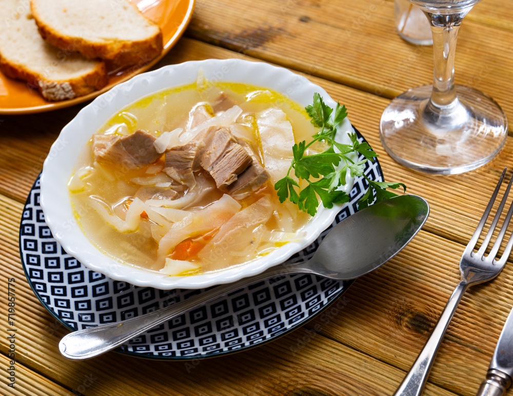 Appetizing Russian dish Shchi - sour cabbage soup served in bowl