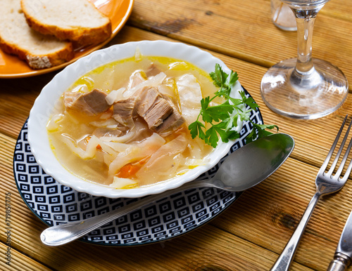 Appetizing Russian dish Shchi - sour cabbage soup served in bowl