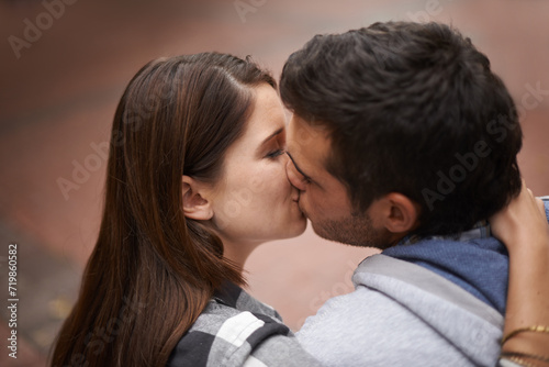 Love, city and face of couple kiss, bonding together and enjoy outdoor date with care, support and partner commitment. Devotion, relationship connection and romantic people in sweet intimate moment