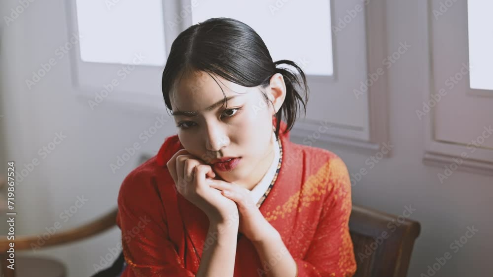 Fashionable close-up portrait of a cool Asian beauty in a red kimono video Fashionable close-up portrait of a cool Asian beauty in a red kimono video