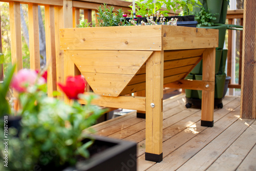 A springtime view of an elevated wooden patio garden planter